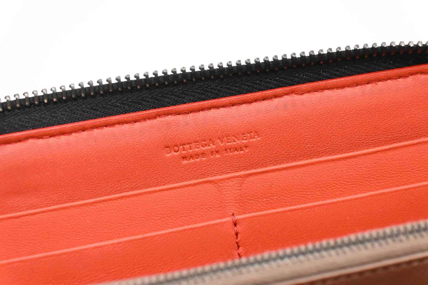 Bottega Veneta Zippy Wallet in Black and Orange Intrecciato Leather