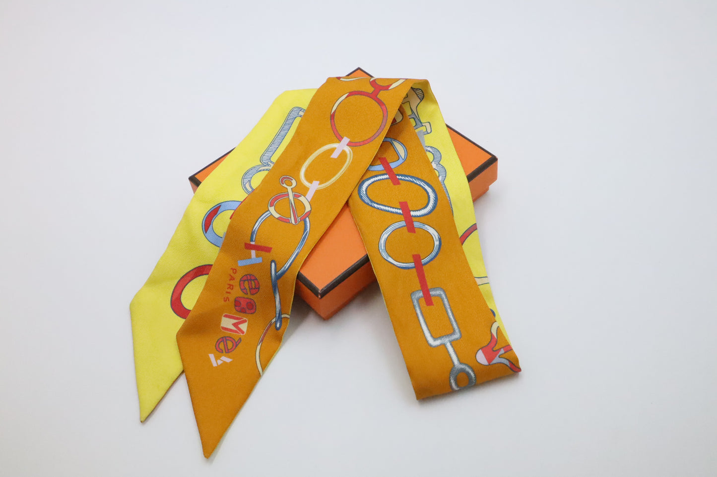 Hermes Twilly 'Do Re Boucles' in Orange & Yellow Silk