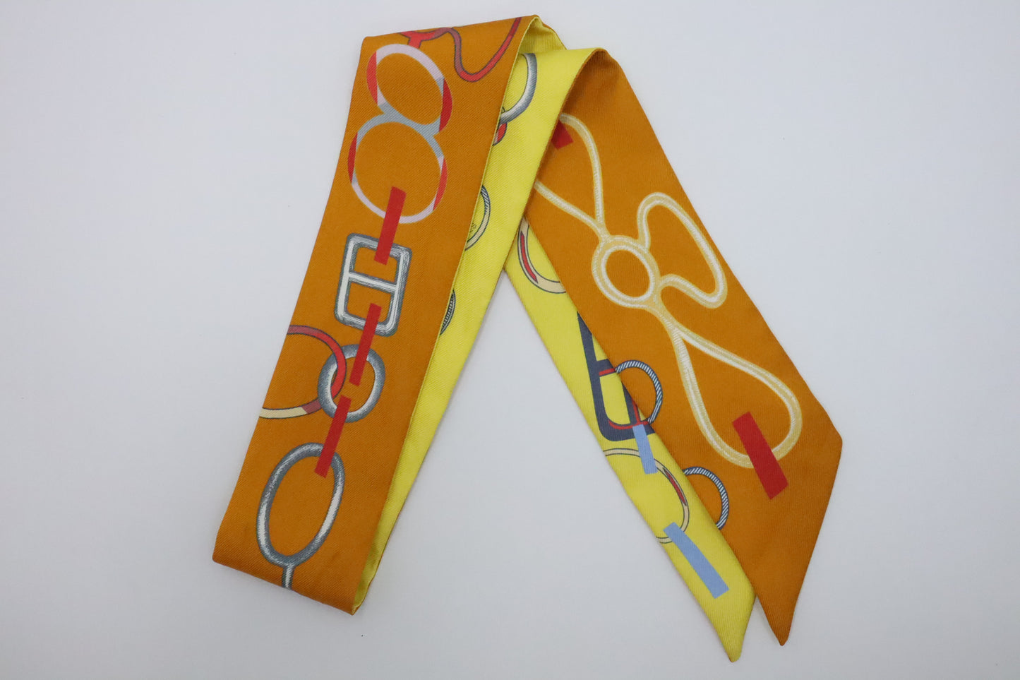 Hermes Twilly 'Do Re Boucles' in Orange & Yellow Silk