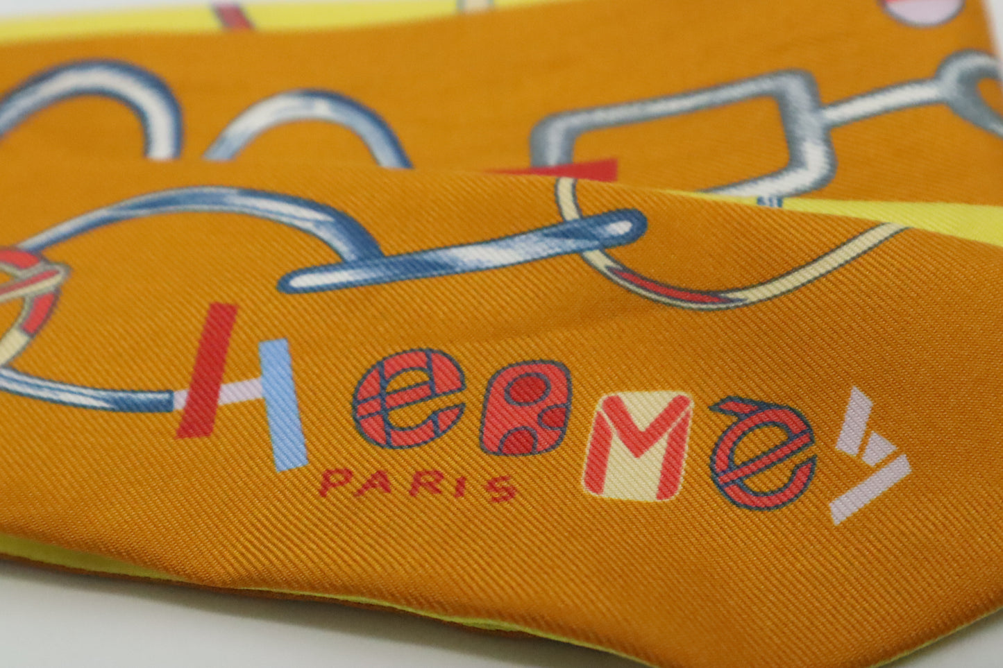 Hermes Twilly 'Do Re Boucles' in Orange & Yellow Silk