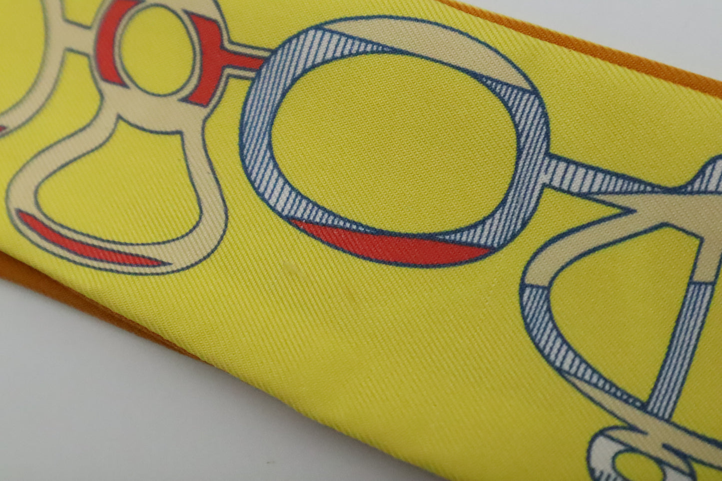 Hermes Twilly 'Do Re Boucles' in Orange & Yellow Silk