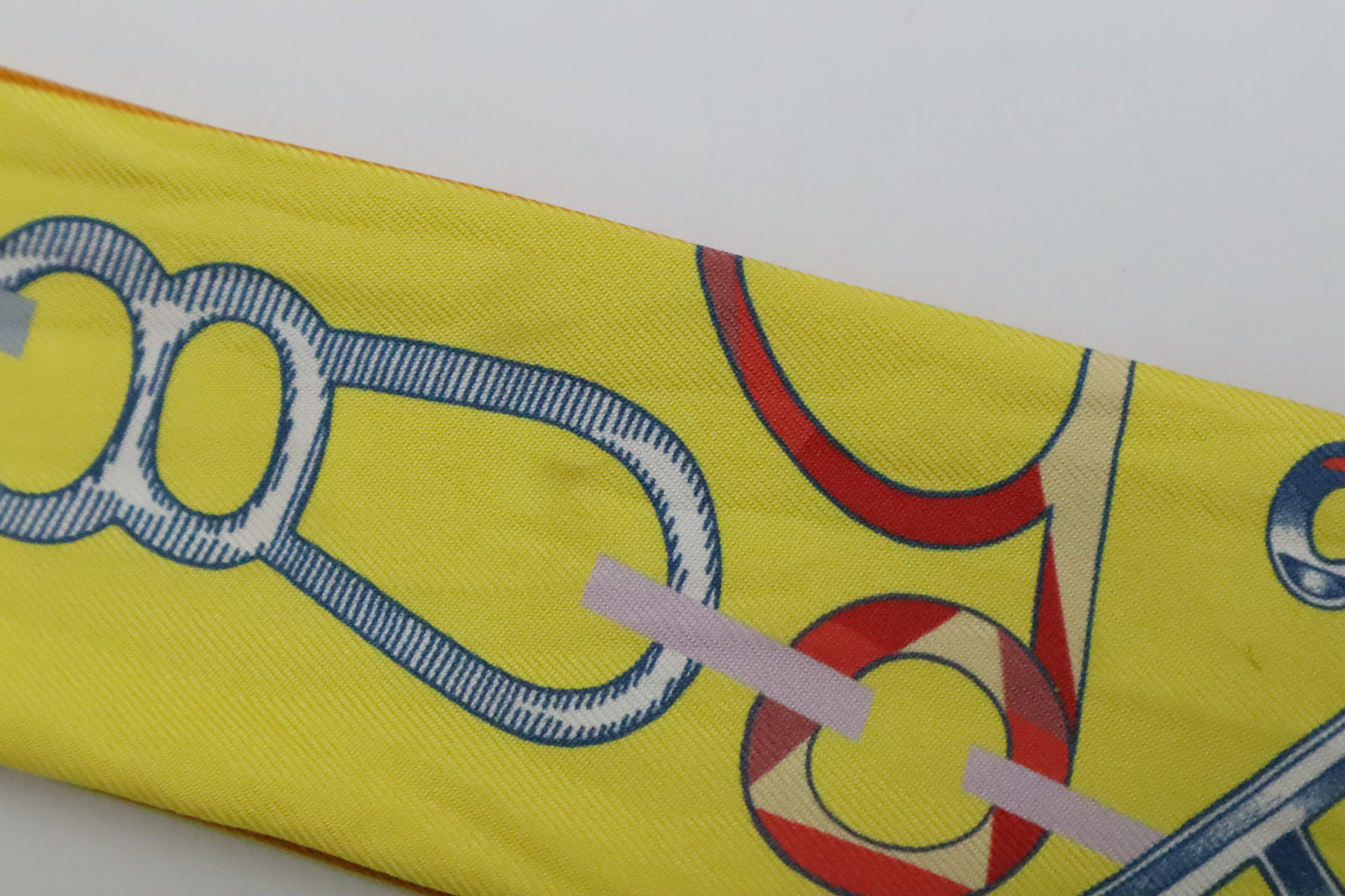 Hermes Twilly 'Do Re Boucles' in Orange & Yellow Silk