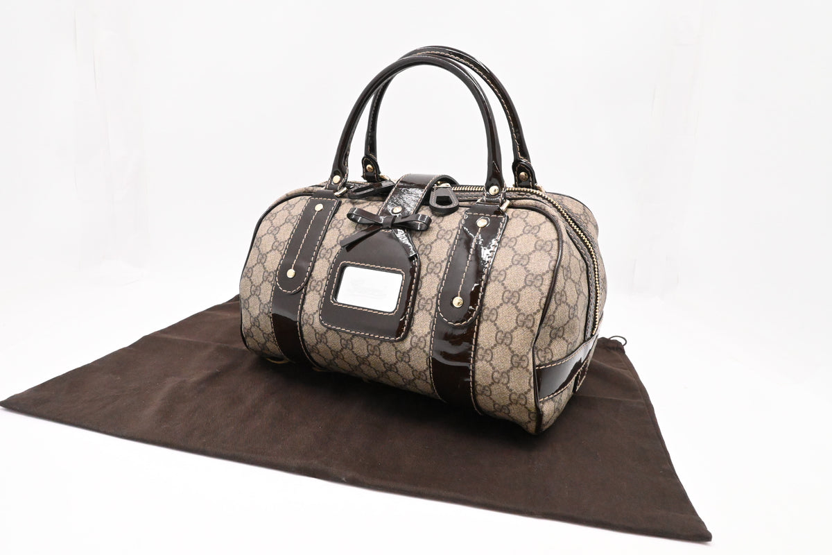 Gucci Boston Bag in GG Supreme Canvas and Brown Patent Leather