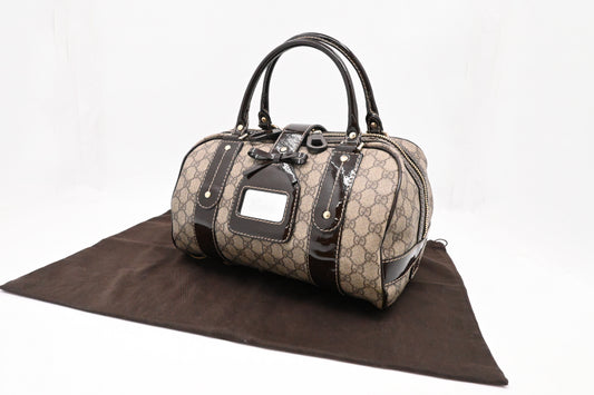 Gucci Boston Bag in GG Supreme Canvas and Brown Patent Leather