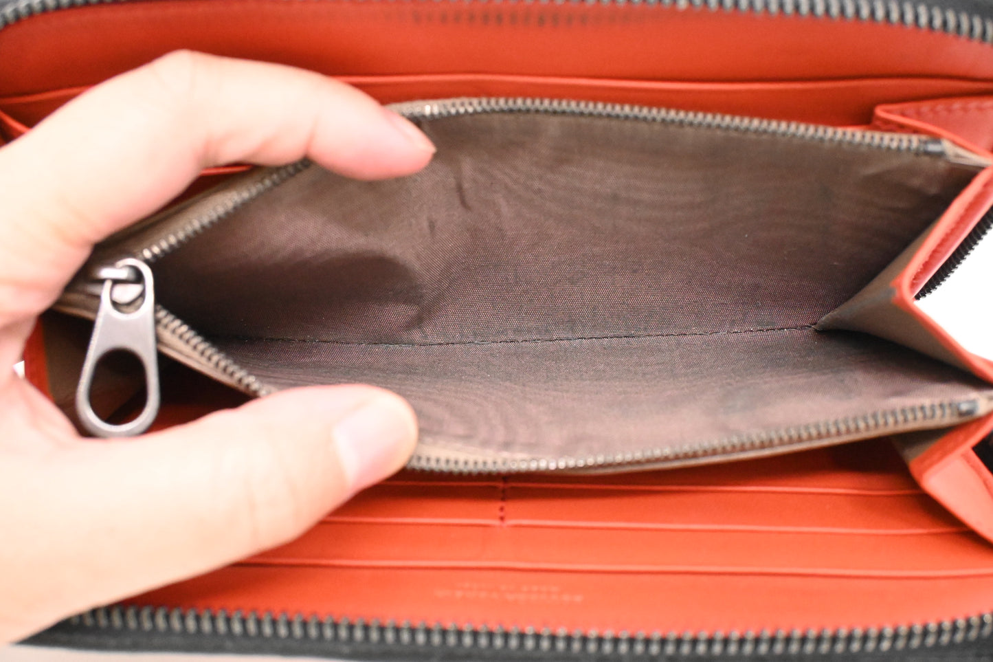 Bottega Veneta Zippy Wallet in Black and Orange Intrecciato Leather