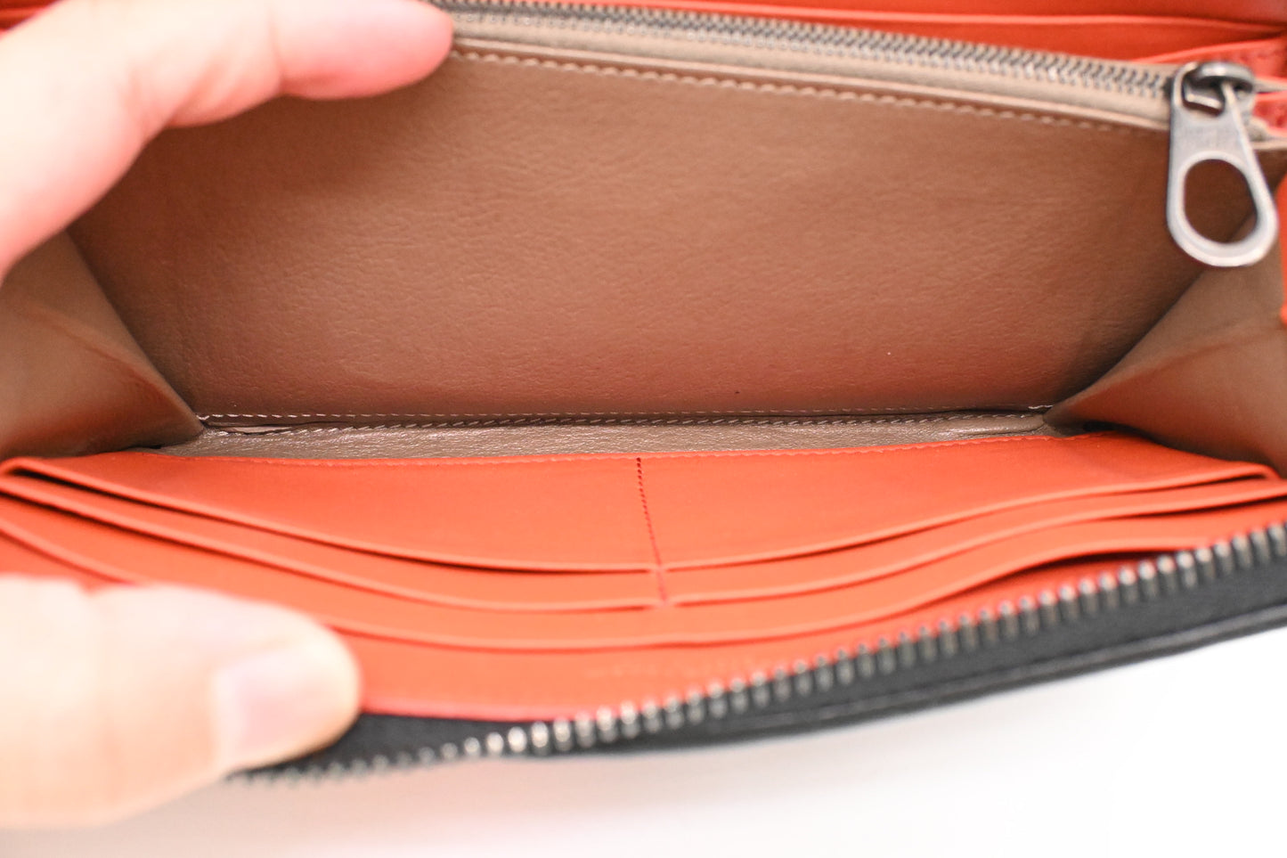 Bottega Veneta Zippy Wallet in Black and Orange Intrecciato Leather