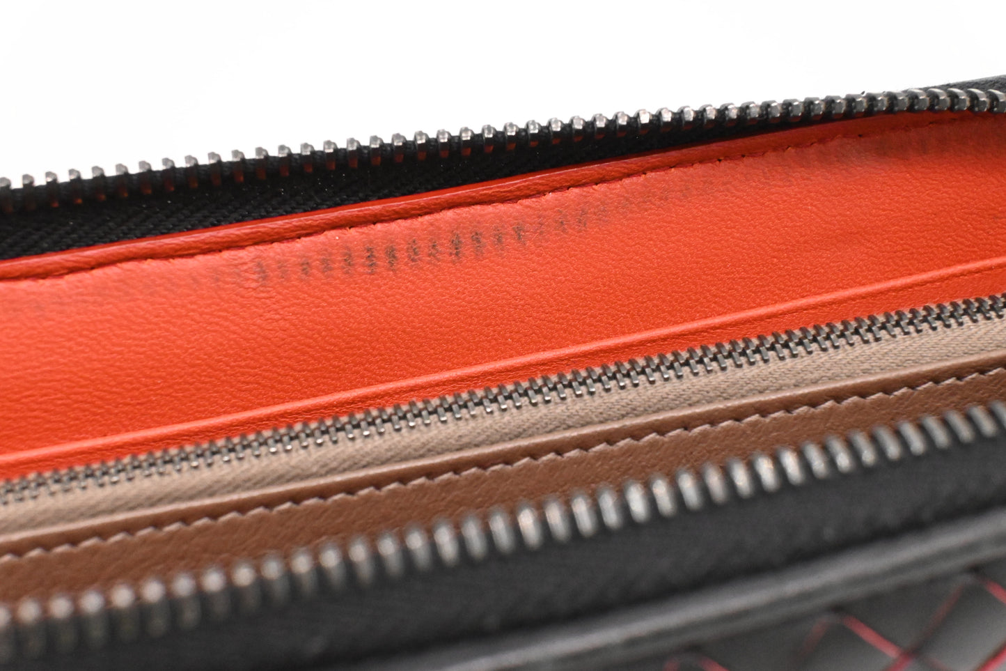 Bottega Veneta Zippy Wallet in Black and Orange Intrecciato Leather